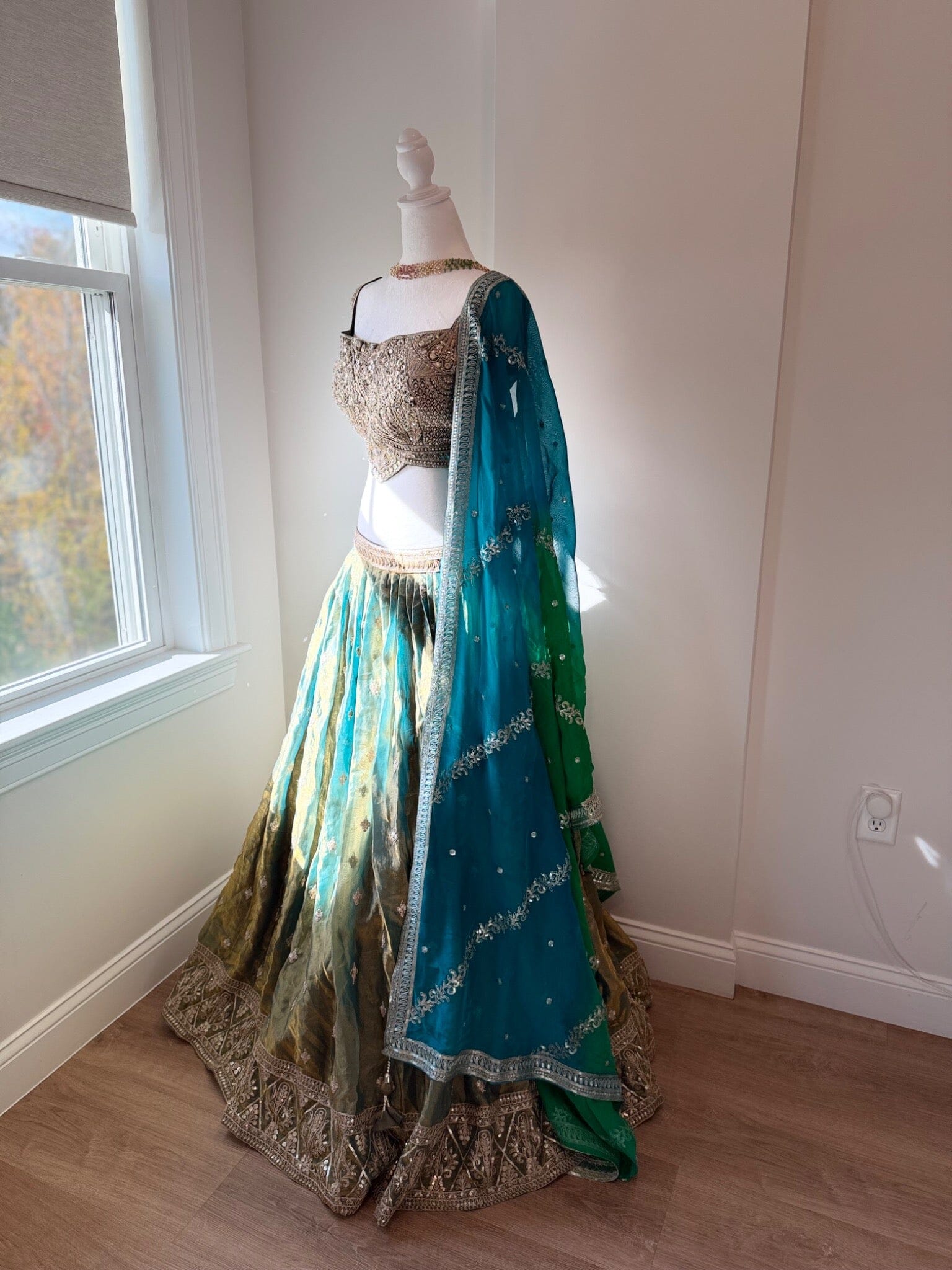 Original garment view of aqua and antique gold lehenga with embellished blouse and teal green dupatta
