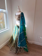 Original garment view of aqua and antique gold lehenga with embellished blouse and teal green dupatta