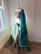Original garment view of aqua and antique gold lehenga with embellished blouse and teal green dupatta