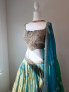 Original garment view of aqua and antique gold lehenga with embellished blouse and teal green dupatta