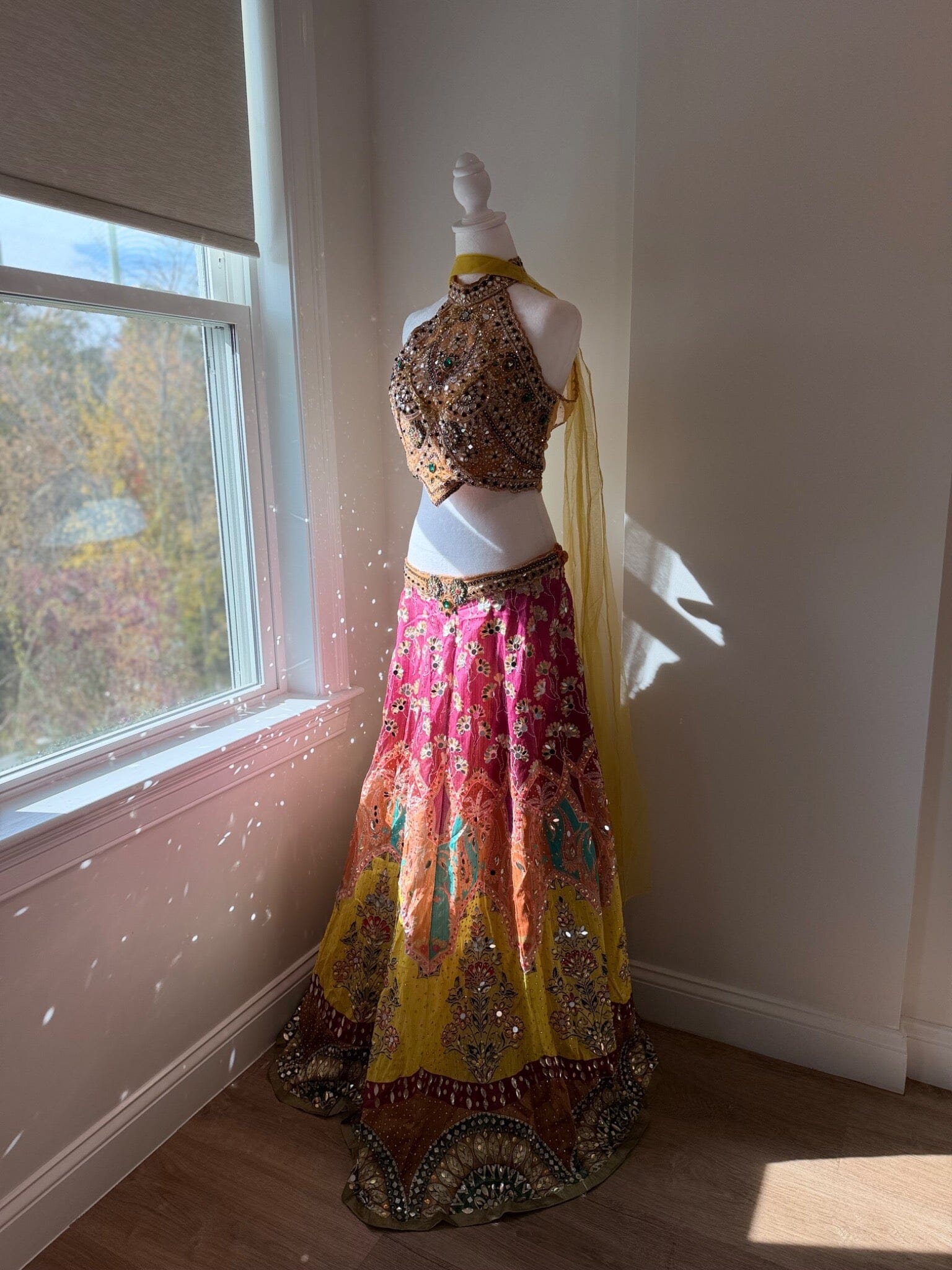 Side angle of multicolored embellished halter lehenga rental set