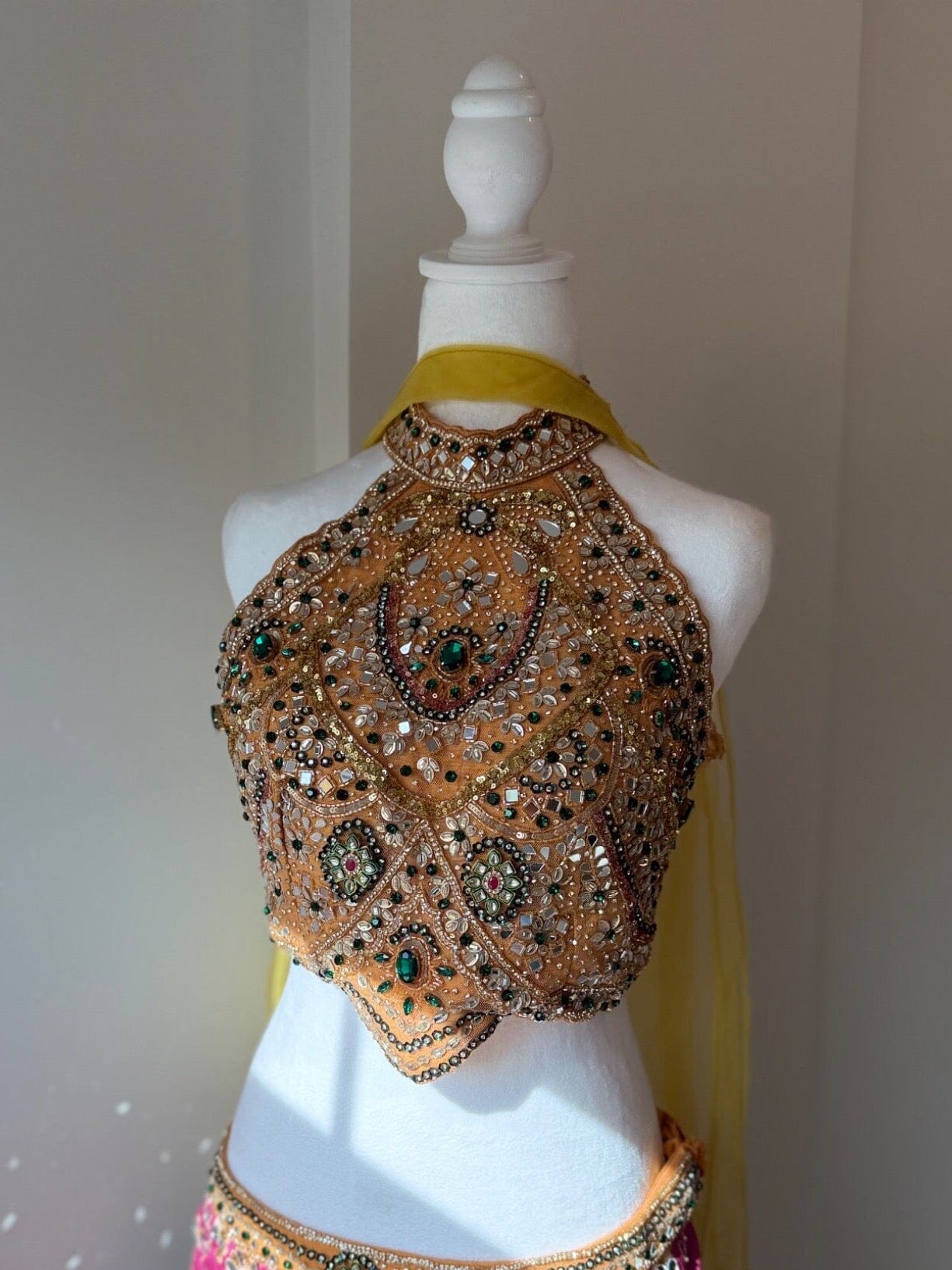 Blouse embellishment detail of multicolored embellished halter lehenga rental set