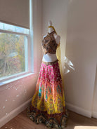 Angled view of multicolored embellished halter lehenga rental set