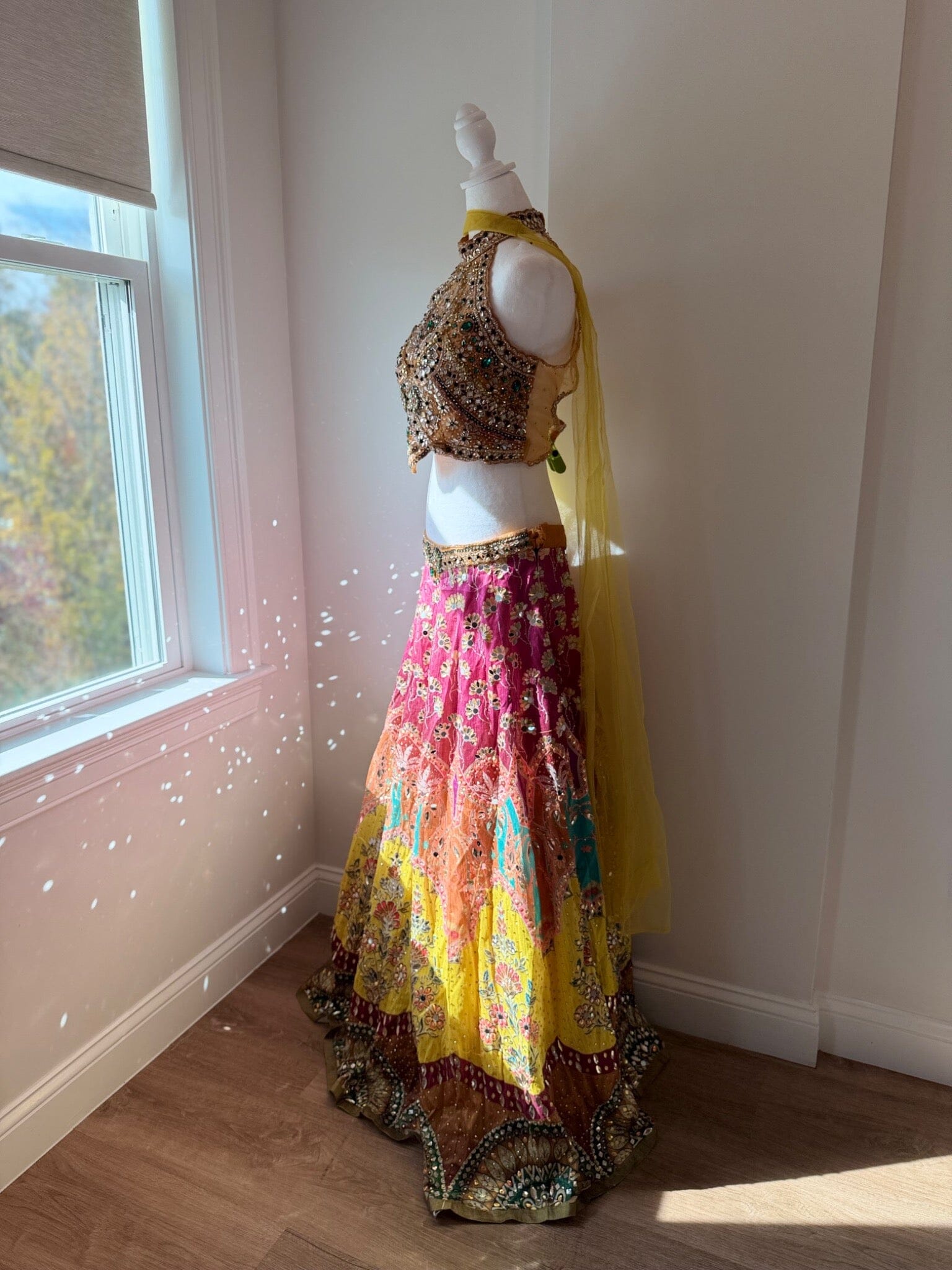 Side view of multicolored embellished halter lehenga rental set